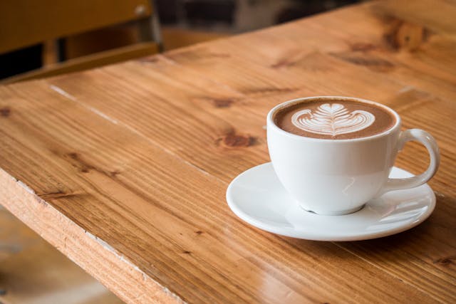 A mug of coffee with a milk design poured into it.