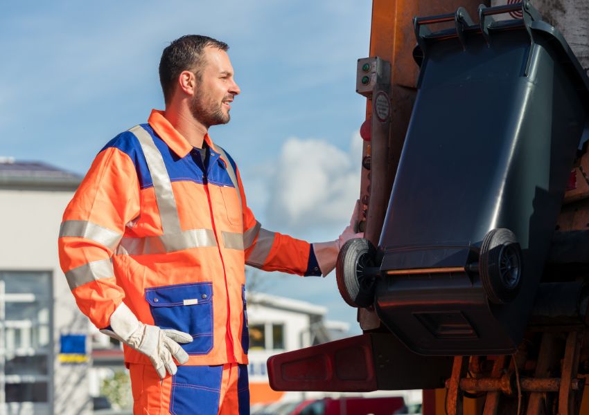 person-lifting-bin-into-truck