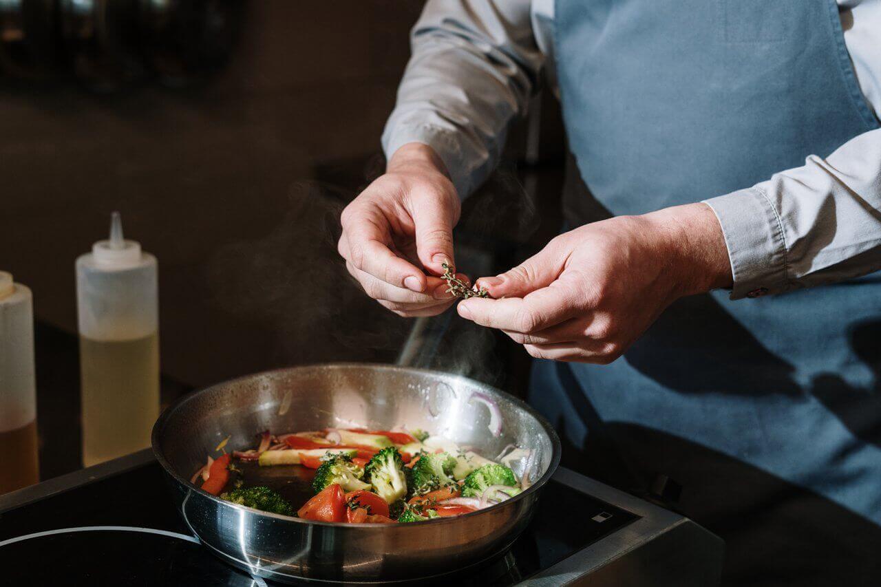 frying vegetables in commercial kitchen