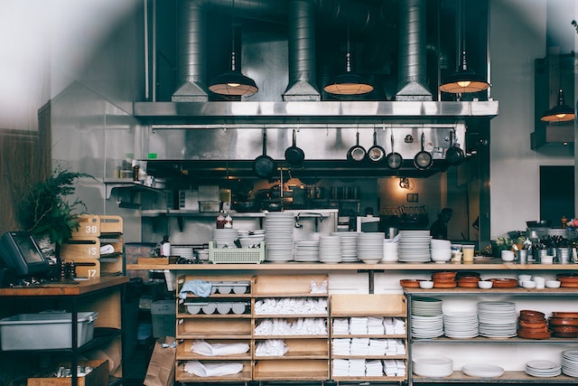 row-of-commercial-kitchen-appliances-from-back